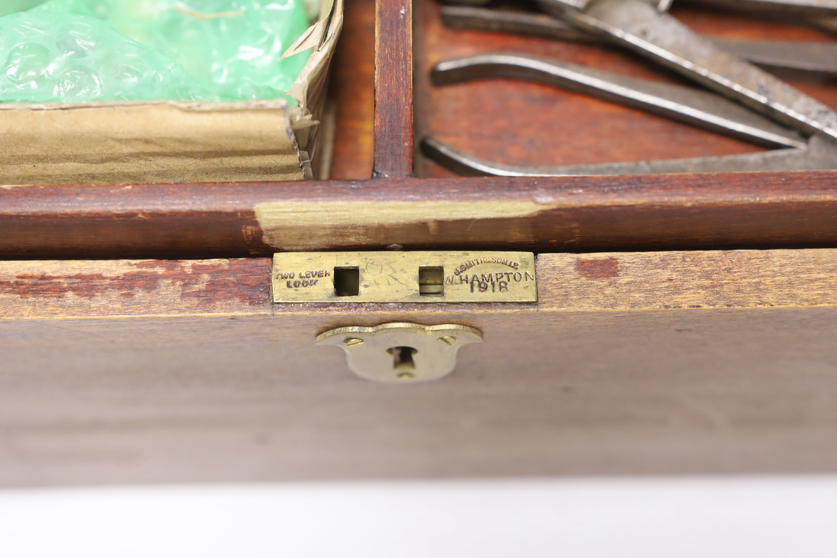 Two mahogany boxes of gun tools, including; bullet moulds, files, a vice, musket balls, etc.